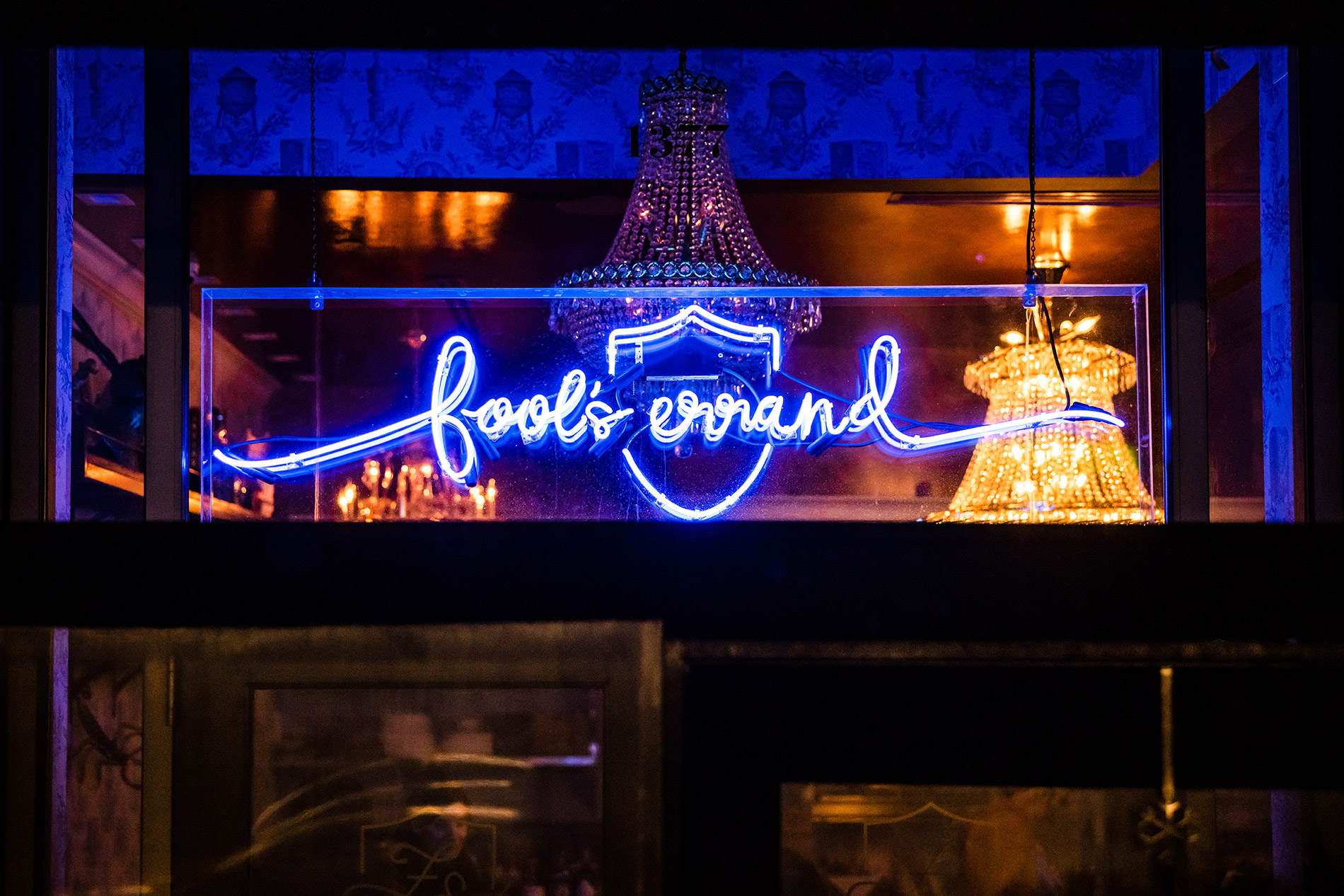 A blue neon side reads Fool's Errand in cursive writing.